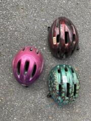 3 various sized bike helmets