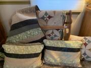 Quilted bedspreads, pillow shams, & handcarved oak rack