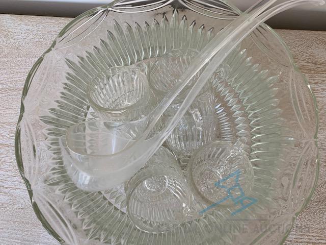 glass punch bowl with 8 glasses and 2 ladles.