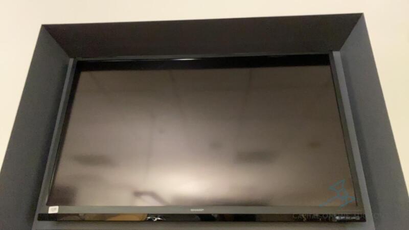 Sharp Television detached from wall with brackets and hardware