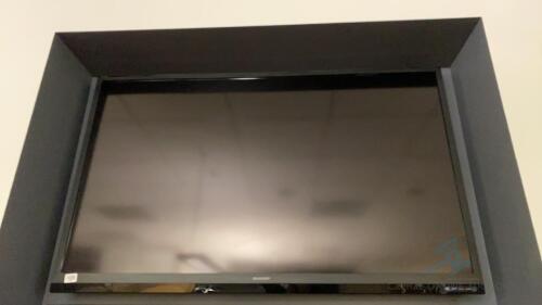 Sharp Television detached from wall with bracket hardware