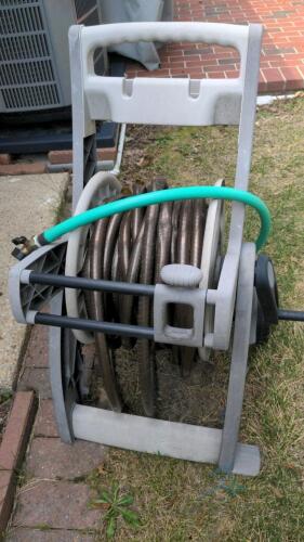 Garden hose reel on wheels and Garden storage container with contents