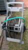 Garden hose reel on wheels and Garden storage container with contents