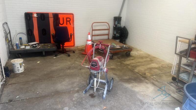 Contents of room including paint sprayer, 4 carts, signs and more