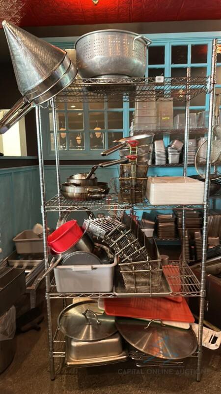 Shelving Unit with Assorted pots, pans, frying baskets, cutting boards and pots. Shelf included