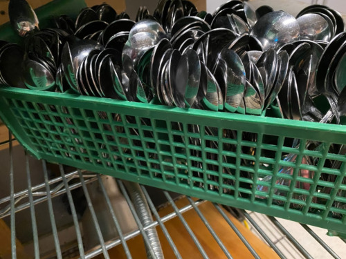 Lot of Soup Spoons in a Utensil rack