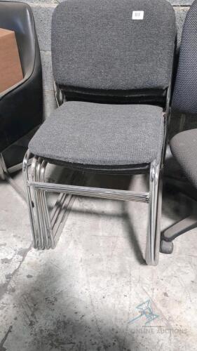 (4) grey stackable chairs