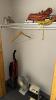 Lot of items in closet including extension cords, vacuum, fan and heater