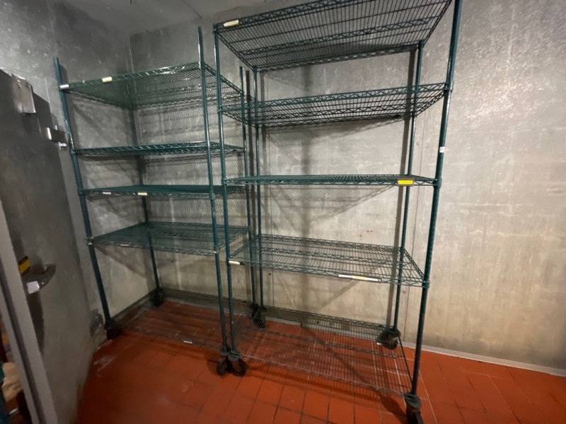 Two green shelving units on wheels